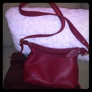 Not a red or burgundy. Somewhere in between Coach